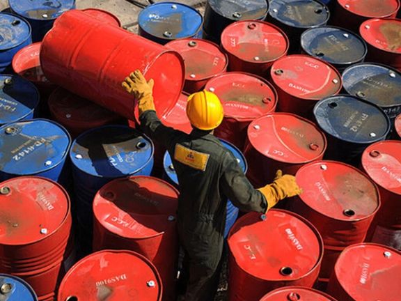 A worker among barrels of Iran’s crude oil